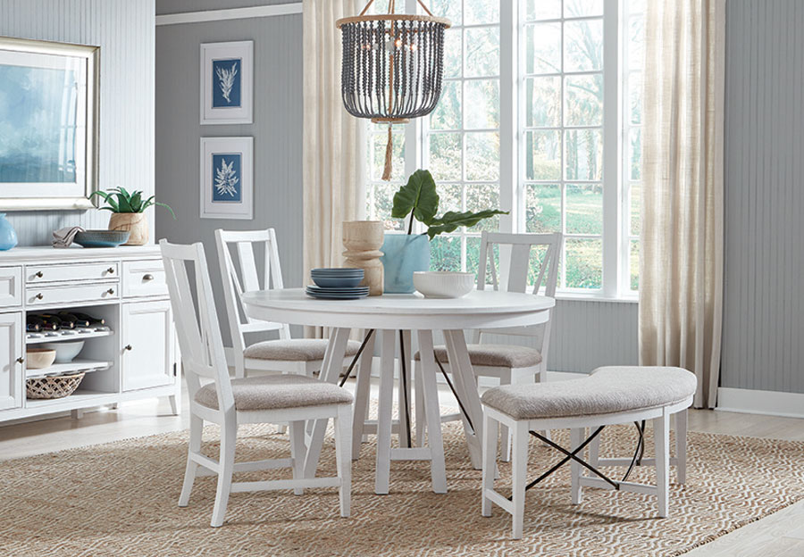 white circular dining table and chairs